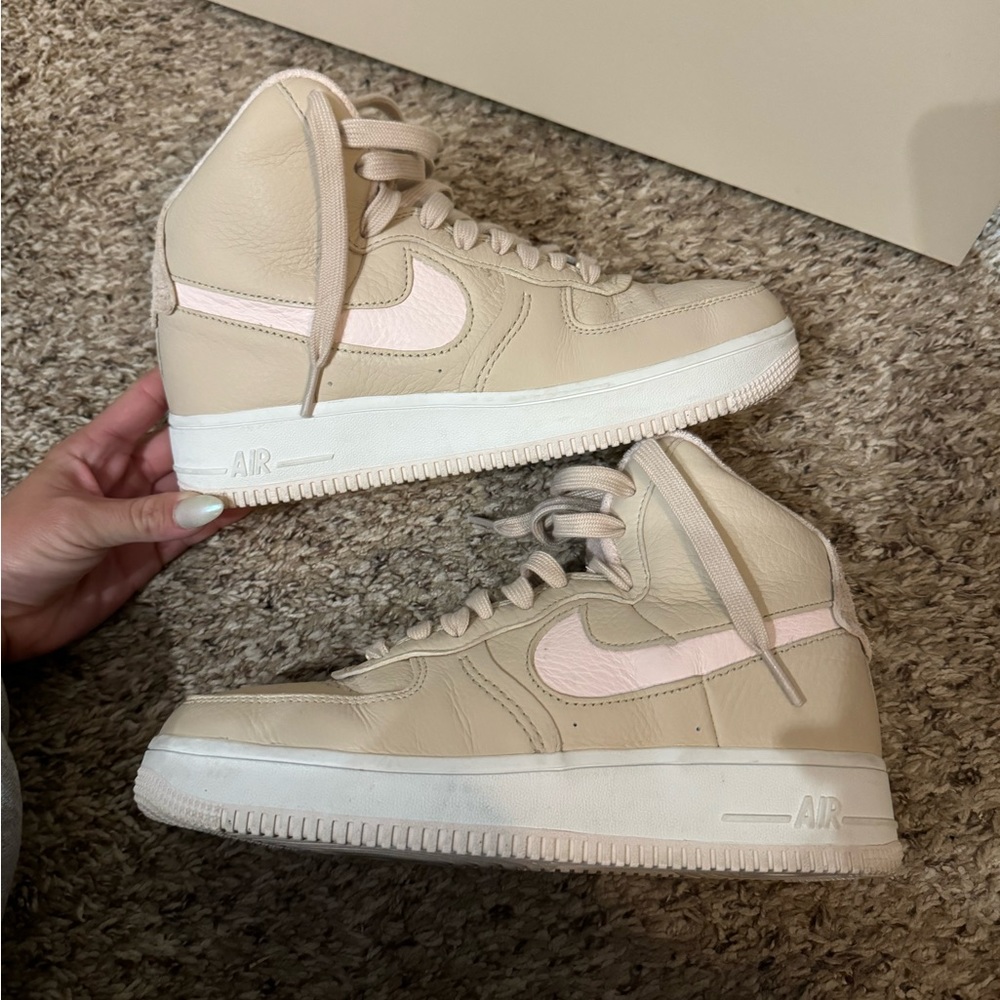 Tan and pink Nike high top shoes